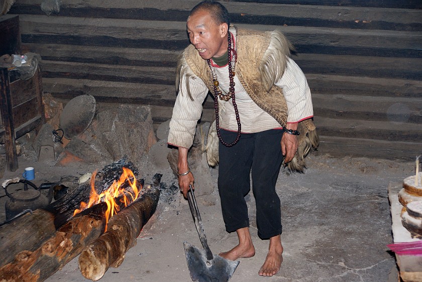 Dongba Village. Man kissing hot metal. Dongba Village. .