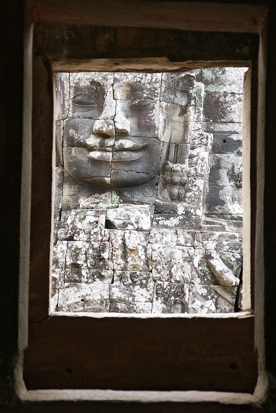 Bayon. Stone Face Through a Window. near Siem Reap. .