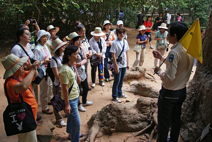 Ta Prohm. Group with Tour Guide. near Siem Reap. .