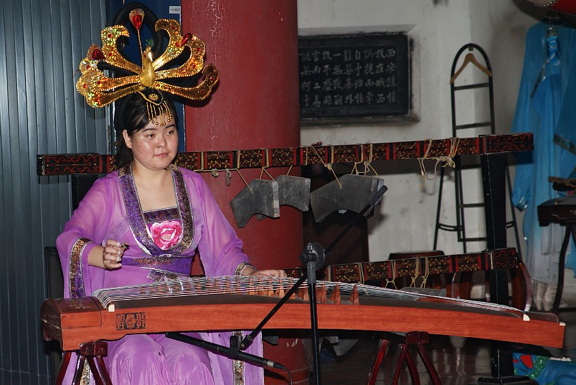 Bell & Drum Tower. Musician Playing the Guzheng Inside the Bell Tower. Xi'an. .