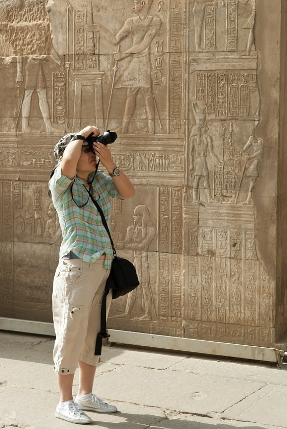 Temple of Kom Ombo. Portrait in front of temple reliefs. Kom Ombo. .