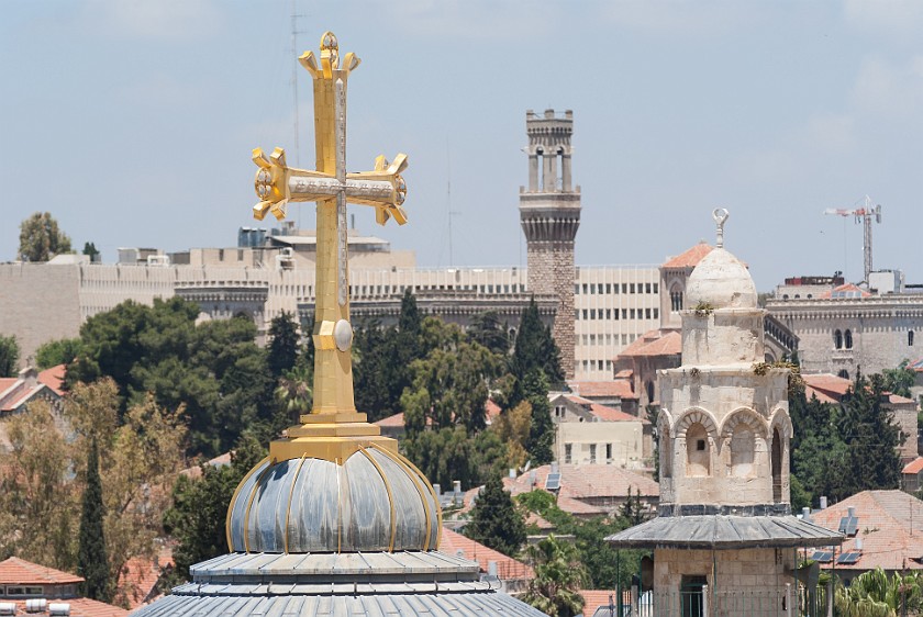Church of the Holy Sepulchre. Cross on top of the main cupola and nearby El-Khanqa minaret. Jerusalem. .