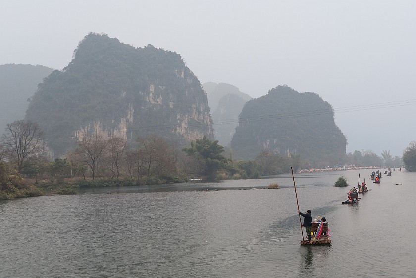 Bicycle Tour Along the Yùlóng Hé River. Tourist rafts at the Yùlóng Hé scenic area. Yángshuò. .