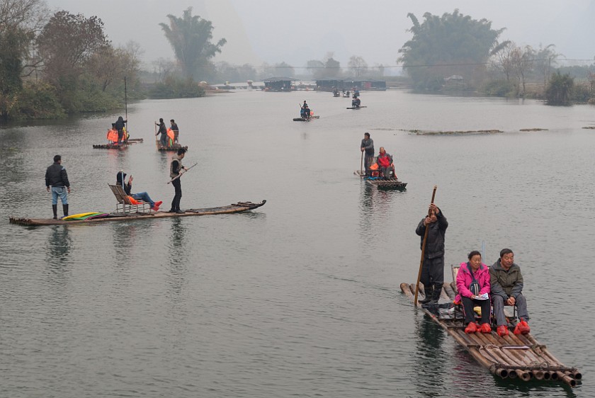 Bicycle Tour Along the Yùlóng Hé River. Tourist rafts. Yángshuò. .