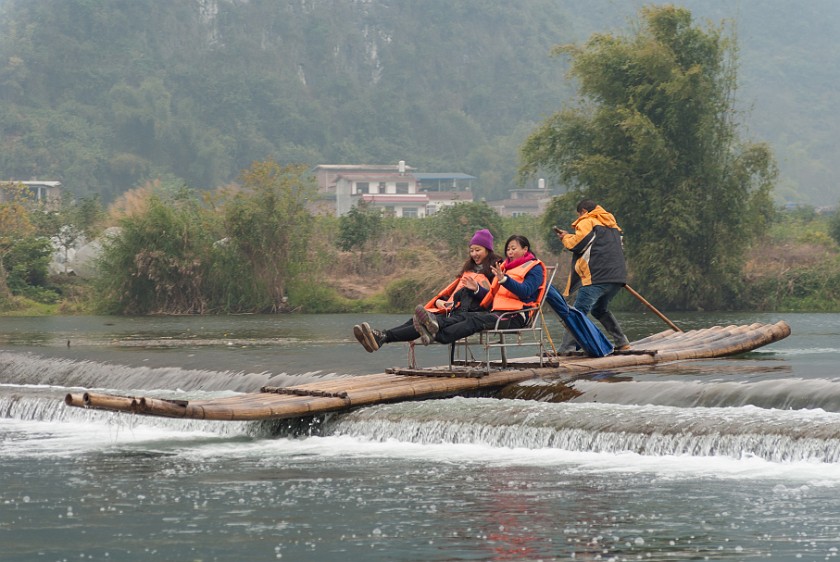 Bicycle Tour Along the Yùlóng Hé River. Raft going over the barrage. Yángshuò. .