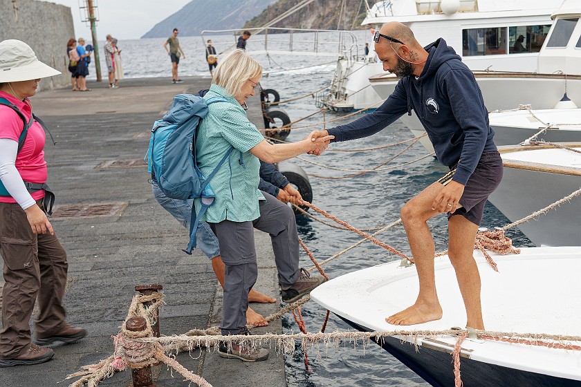 Hiking on Vulcano. Friend entering a boat. Lipari. .