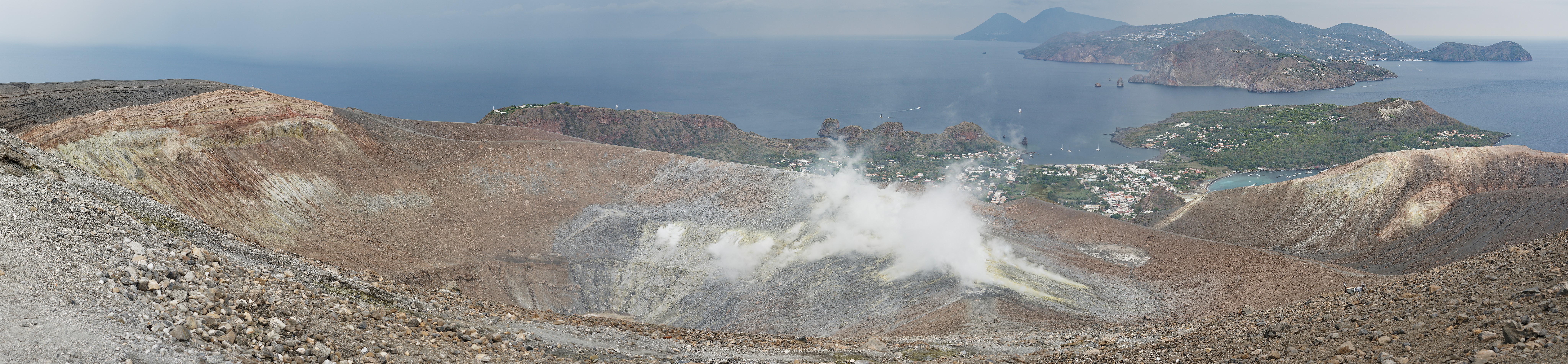 Hiking on Vulcano. Panoramic view of the crater, Vulcanello, Lipari and Salina. Vulcano. .